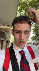 Tattooed young man in business attire walks Buenos Aires sidewalk