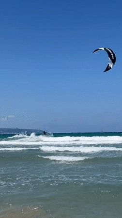 Kitesurfing session and beach activities captured in Acre, Israel