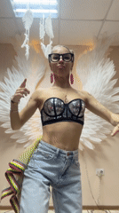 Woman dances before angel wing backdrop in Abakan