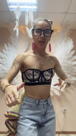 Woman dances before angel wing backdrop in Abakan