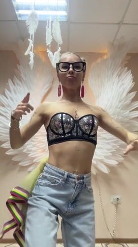 Woman dances before angel wing backdrop in Abakan