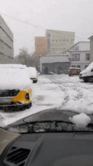 Snowy morning commute captured in Moscow showing yellow cars