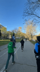 Group runs through Blagoevgrad park carrying black flag