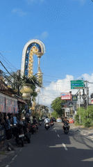 Midday motorcycle traffic on a Kuta Selatan street