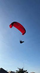 Paragliders fill the sky over Kuta Selatan's coastal cliffs