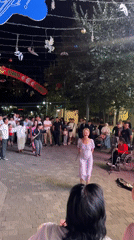 Almaty street fest: dancing, live music, and string lights at night