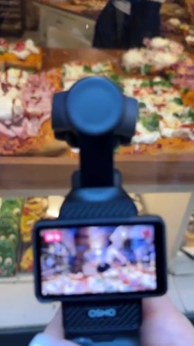 Tourist documents Bergamo's pizza shops and historic fountain