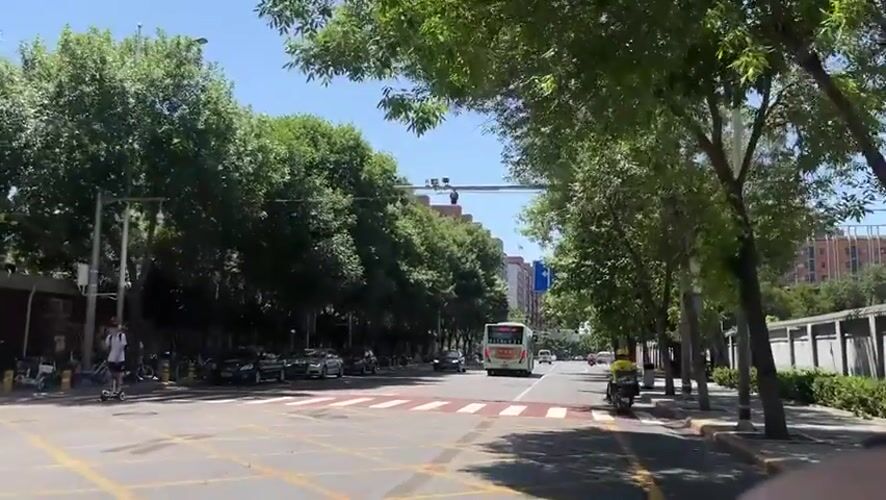 Morning traffic observed on marked road in Beijing suburb