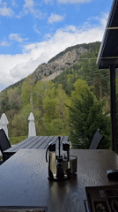 Restaurant patron documents mountain views from Sapareva Banya dining establishment
