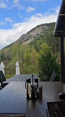 Restaurant patron documents mountain views from Sapareva Banya dining establishment