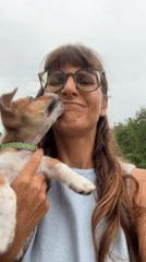 Woman holds puppy outdoors in Kediri, Indonesia
