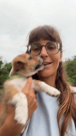 Woman holds puppy outdoors in Kediri, Indonesia