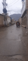 Street scene captured in small mountain town during cloudy weather