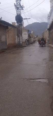 Street scene captured in small mountain town during cloudy weather