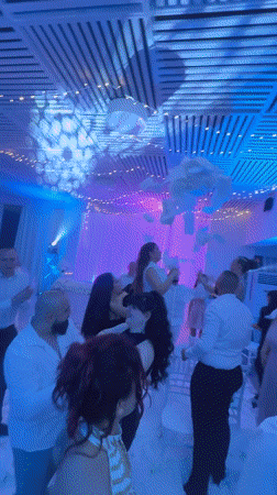 Wedding reception features dancing guests, colorful lights in Topola