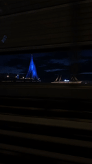 Vehicle captures nighttime drive past illuminated bridge in Saint Petersburg