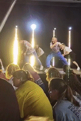 Outdoor Zumba event with stage instructors and a big crowd