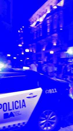 Night crowd celebrates as police escort person in Buenos Aires