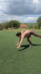 Woman performs gymnastics routine on field in Tvarditsa, Bulgaria