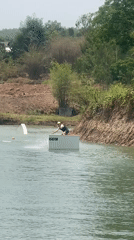 Wakeboarder navigates platform on lake in northern Thailand