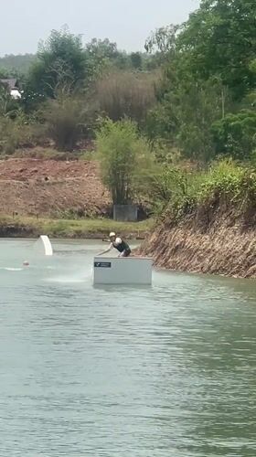Wakeboarder navigates platform on lake in northern Thailand