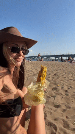 Beach afternoon in Engels: corn, a bridge, and a passing helicopter.