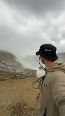 Tourists visit volcanic crater with turquoise lake in Indonesia