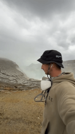 Tourists visit volcanic crater with turquoise lake in Indonesia