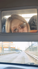 Woman takes car selfie during drive through Chaikovsky industrial area