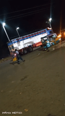 Busy roadside night: street food, vehicles, and local activity