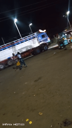 Busy roadside night: street food, vehicles, and local activity