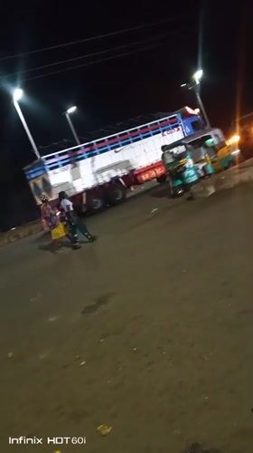Busy roadside night: street food, vehicles, and local activity