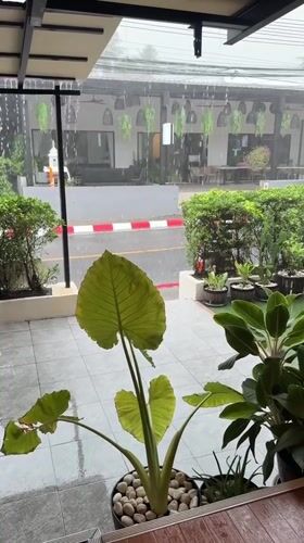 Rainstorm and restaurant scenes captured in Thai coastal village