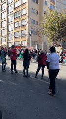 Crowd gathers on La Paz street facing same direction