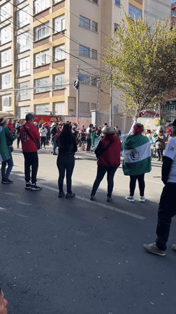 Crowd gathers on La Paz street facing same direction