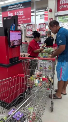 Late-night shopping continues at Patong Makro during rain shower