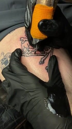 Late-night tattoo session documented in Ushuaia, Argentina