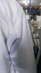 Person in white garment filmed among similarly dressed individuals