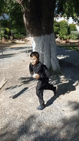 Child plays with balls in Pakistani village yards
