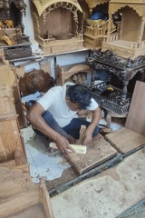 Artisan carves religious artifacts in bustling Mumbai marketplace