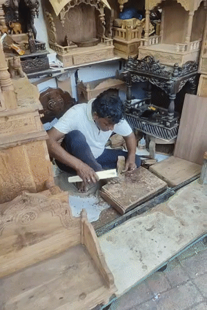 Artisan carves religious artifacts in bustling Mumbai marketplace