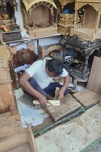 Artisan carves religious artifacts in bustling Mumbai marketplace