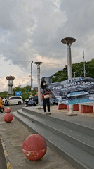 Women hold fire donation banner in Lhokseumawe