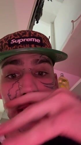 Tattooed man in Supreme cap filmed in Buenos Aires