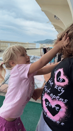 Family enjoys afternoon playtime on Sochi oceanfront patio