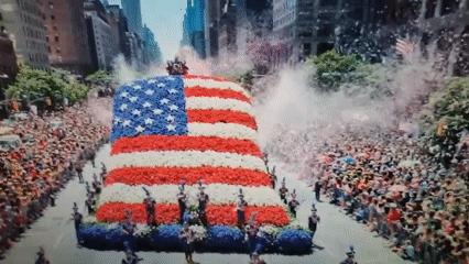 Flower-covered American patriotic float parades through Romanian streets