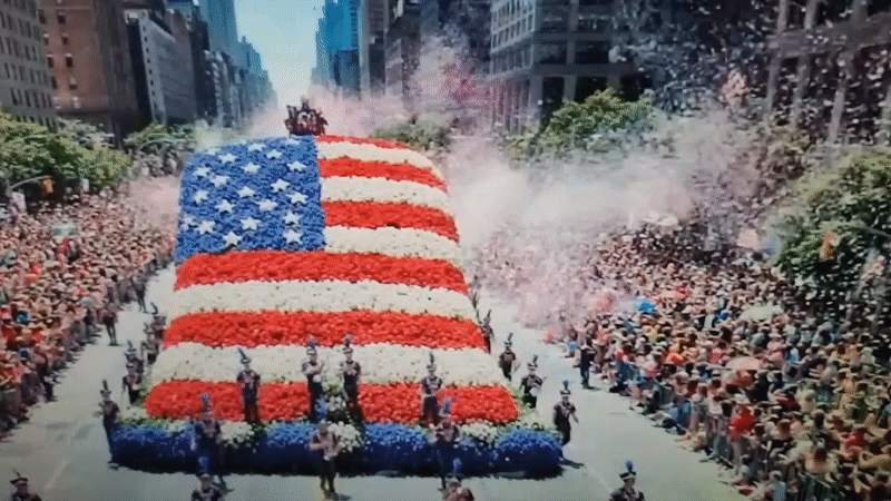 Flower-covered American patriotic float parades through Romanian streets