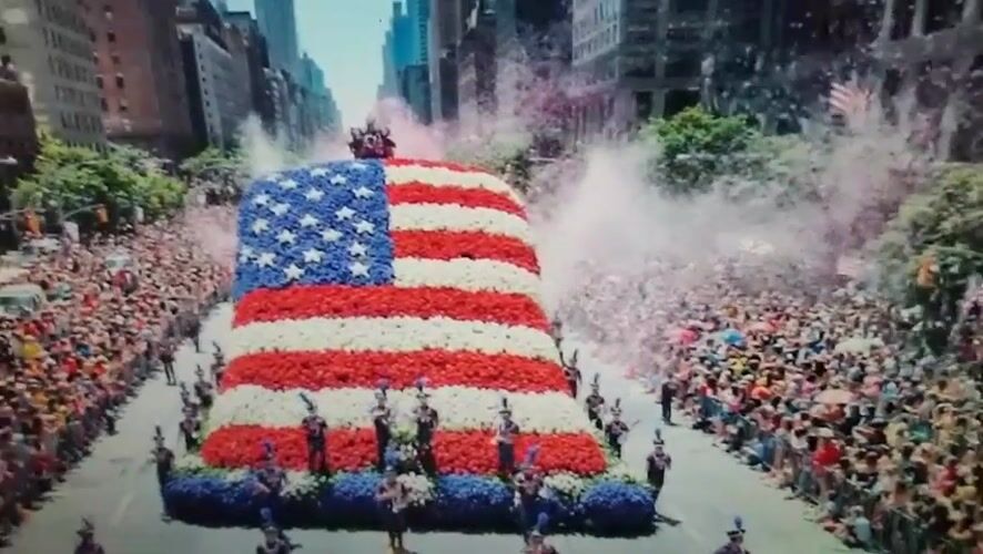 Flower-covered American patriotic float parades through Romanian streets