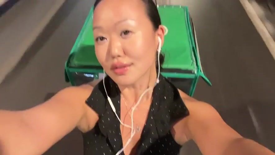 Woman films selfie video while riding scooter in Thailand