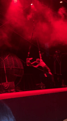Aerial rope act unfolds under red lights in Tangier